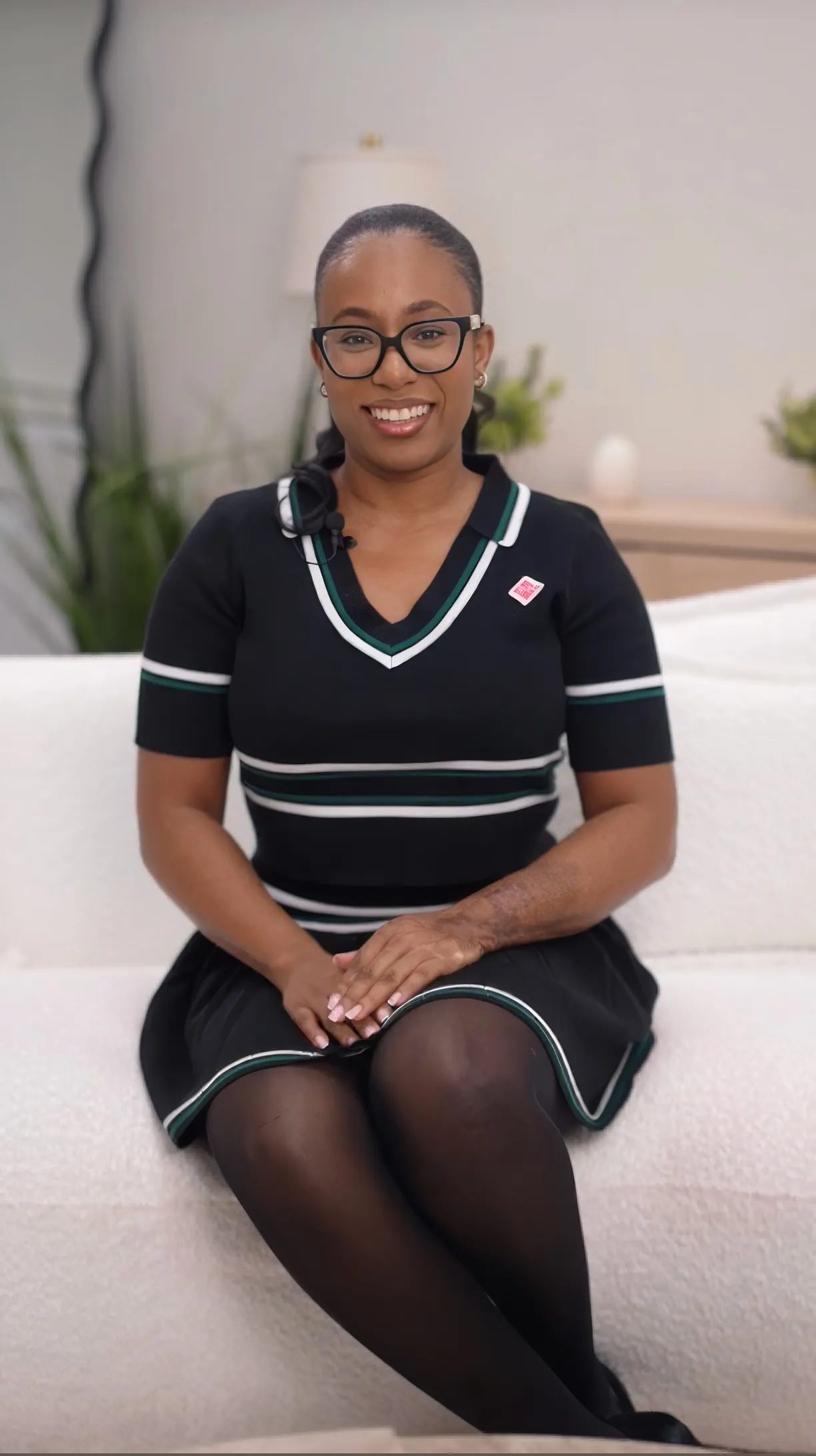 A smiling Remotely founder seated in a warm studio setting